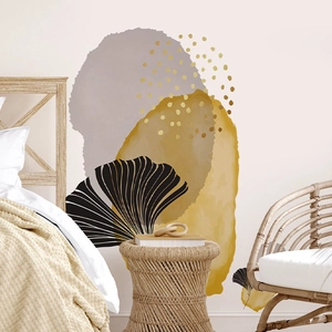 Detail of abstract geometric wall sticker with ginkgo leaves and gold dots on bedroom wall
