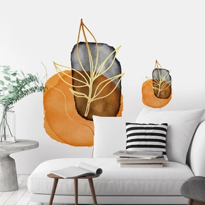 Detail showing self-adhesive wall stickers with golden leaf outlines on geometric circles