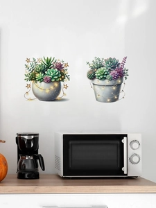 Close-up of succulent wall decals with decorative warm star lights on a white kitchen wall