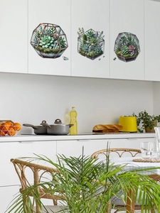 Dettaglio dell'adesivo murale terrario geometrico con succulente e cristalli su un mobile