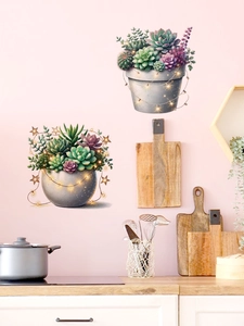 Detail view of PVC succulent wall stickers with warm star lights on light pink wall