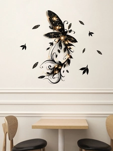 Detail of black butterfly wall sticker with gold spots in modern minimalist dining room