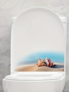 Detail of beach themed toilet seat sticker with starfish and seashell on sand