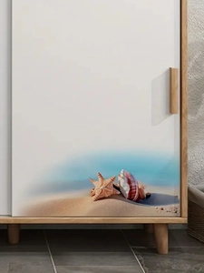 Detail of a modern wooden cabinet featuring beach shell prints on sliding white doors