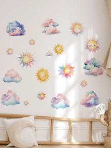 Nursery wall sticker detail showing watercolor sun and clouds in soft pastel colors