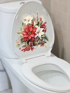Detail of festive Christmas poinsettia and pine cone stickers on a white toilet lid