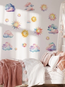 Detailed view of watercolor sun and cloud wall stickers in a cozy child bedroom decor
