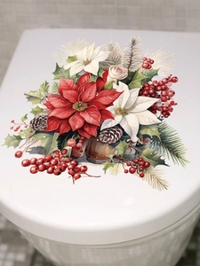 Detail of Christmas poinsettia decal with red berries and pine needles on toilet lid