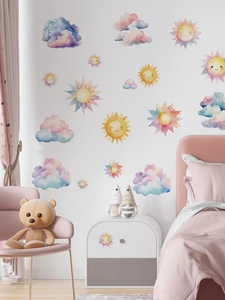 Detailed view of watercolor sun and clouds wall stickers in a cozy nursery room setting