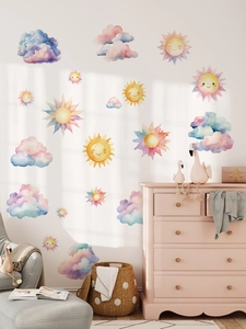 Detail of watercolor rainbow sun and cloud wall stickers in a cozy nursery room setting