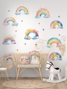Watercolour rainbow wall stickers shown as decor in a cozy modern nursery room setting