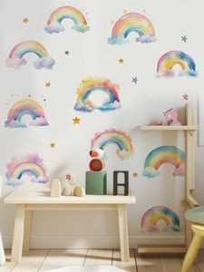Detailed view of watercolor rainbow wall stickers with clouds and stars in a child's bedroom