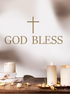 Detail of gold God Bless cross wall decal on wall with candle and floral decor
