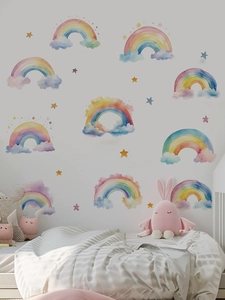Detail of watercolor rainbow and cloud wall stickers in a cozy child's bedroom setting