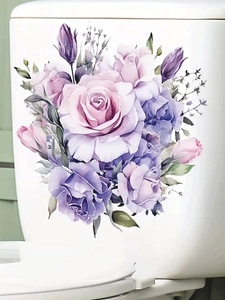 Detail of floral watercolor rose sticker applied on white ceramic toilet tank surface