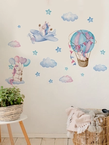 Detail of unicorn pilot wall stickers with hot air balloons and clouds in a nursery room