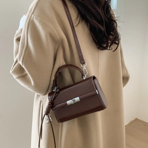 Deep brown vintage PU leather crossbody bag with adjustable strap shown on a female model