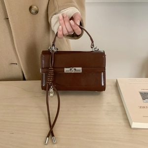 Detail of dark brown lychee texture PU leather shoulder strap with adjustable D-ring buckle