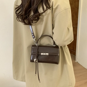 Retro dark brown waxed leather handbag with metal turn-lock and heart charm detail