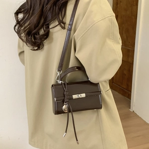 Detail view of adjustable dark brown PU leather shoulder strap with durable D-ring buckle