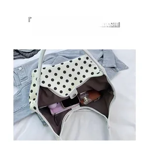 Top view of nylon crossbody bag interior showing large capacity for phone and notebook