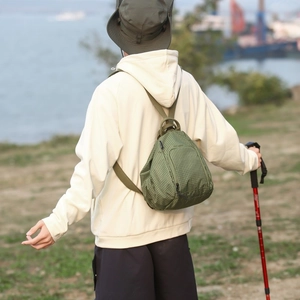 Détail du sac bandoulière en nylon à carreaux vert olive avec double fermeture éclair