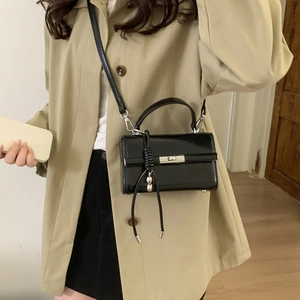 Adjustable black lychee textured PU leather shoulder strap with silver D-ring buckle