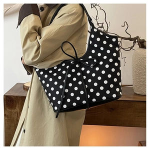Detail of the large capacity nylon tote bag with black and white polka dot pattern design