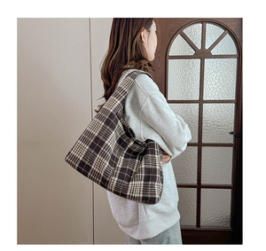 Retro plaid tote bag in brown and beige fabric shown on shoulder for daily use