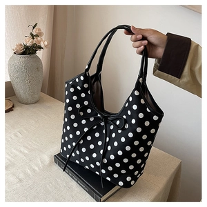Detail of nylon polka dot tote bag with black bow decoration and large capacity