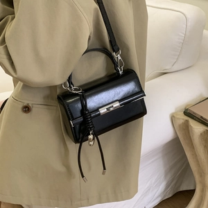 Detail of black pebbled PU leather shoulder strap with adjustable D-ring metal buckle