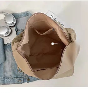Internal view of beige nylon tote bag with zipper pocket and open slot for iPad storage