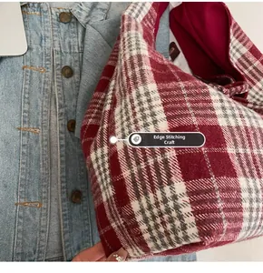 Detailed view of the red plaid tote bag showcasing precise crimping process texture