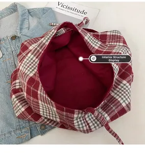Detail view of the red plaid canvas tote bag showing the spacious burgundy interior lining
