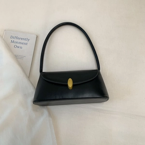 Classic black leather underarm bag with gold oval twist lock and a sleek trapezoid design
