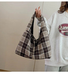 Side view of a vintage checkered tote bag worn by a model to show capacity and fit