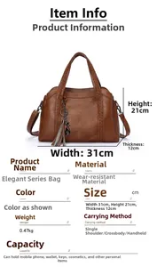 Detailed view of brown handbag showing V-shaped stitching and tassel charm decoration