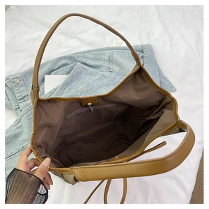 Detail view of large nylon tote bag interior with zipper pocket and magnetic closure