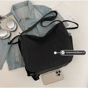 Capacity detail of black checkered hobo bag shown alongside an iPad and smartphone