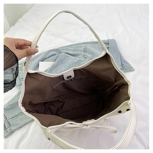 Top view of spacious white polka dot nylon tote bag with inner zipper pocket and magnetic closure