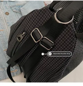 Detail view of adjustable wide shoulder strap and metal buckle on black checkered backpack