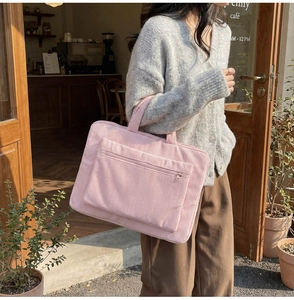 Pink corduroy laptop tote bag with soft texture and front zipper pocket detail