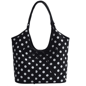 Polka dot nylon tote bag with white spots and black bow tie decoration on white background