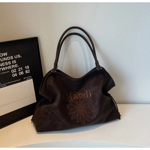 Brown suede tote bag with daisy embroidery and top handles for casual use