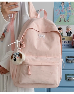 Pink backpack with bow pattern, white embroidery and plush puppy charm for students