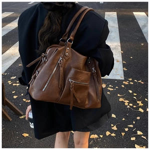 Detailed view of dark brown PU leather tote bag with stylish zippers and large capacity
