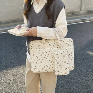 Detail of off-white corduroy tote bag with butterfly heart print and small matching pouch