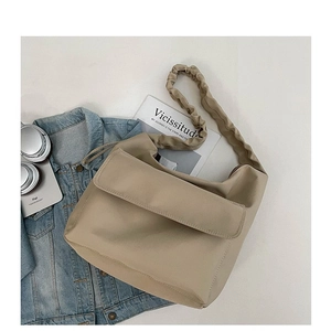 Minimalist beige nylon crossbody bag with ruched strap and stylish casual fashion flair