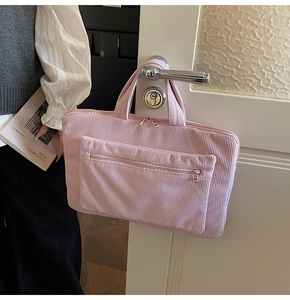 Pink corduroy laptop bag featuring large capacity main pocket and front zipper pouch