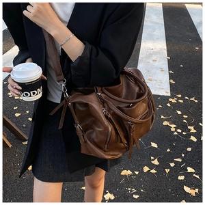 Detailed view of deep brown large capacity PU leather shoulder bag with tassels
